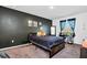 Cozy bedroom featuring a dark accent wall, plush carpet, and a dedicated study space at 136 Columbia Dr, Kissimmee, FL 34759