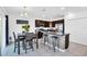 Modern kitchen features dark cabinetry, stainless steel appliances and kitchen island with tile flooring at 136 Columbia Dr, Kissimmee, FL 34759