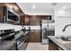 Modern kitchen with stainless steel appliances, dark cabinets, and ample counter space at 136 Columbia Dr, Kissimmee, FL 34759