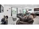 Comfortable living room with tile flooring, a cozy couch and well lit with natural light at 136 Columbia Dr, Kissimmee, FL 34759