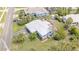 Aerial view of a light blue home featuring a well-maintained lawn, metal roof, and a detached shed at 1420 N Grandview Ave, Daytona Beach, FL 32118