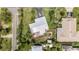Aerial view of a property featuring a metal roof, patio with furniture, a lush yard, and a driveway at 1420 N Grandview Ave, Daytona Beach, FL 32118