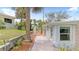 Cozy backyard area featuring a small patio with orange chairs and a glimpse of the home's exterior at 1420 N Grandview Ave, Daytona Beach, FL 32118