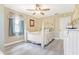 Charming bedroom featuring a ceiling fan, natural light from the window, and a four-poster bed at 1420 N Grandview Ave, Daytona Beach, FL 32118