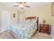 Bedroom featuring a ceiling fan, laminate flooring, and a comfortable bed with a floral pattern at 1420 N Grandview Ave, Daytona Beach, FL 32118