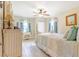 Comfortable bedroom featuring a ceiling fan, natural light from the windows, and a four-poster bed at 1420 N Grandview Ave, Daytona Beach, FL 32118