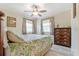 Comfortable bedroom with wood accents, natural light, and a dark wood dresser with ornate hardware at 1420 N Grandview Ave, Daytona Beach, FL 32118