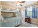 Inviting ' bedroom featuring bunk beds, a ceiling fan, and a window with patterned curtains at 1420 N Grandview Ave, Daytona Beach, FL 32118