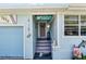 Close up of beach themed entryway with decorative surfboard, nautical decorations, and a 'Welcome Paradise Found' sign at 1420 N Grandview Ave, Daytona Beach, FL 32118