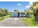 Charming light blue home featuring a single-car garage, well-kept lawn, and decorative nautical accents at 1420 N Grandview Ave, Daytona Beach, FL 32118