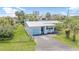 Charming light blue single-story home with a metal roof, a single-car garage, and a well-maintained lawn at 1420 N Grandview Ave, Daytona Beach, FL 32118