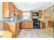Traditional eat-in kitchen features wood cabinets, tile backsplash, and stainless steel appliances at 1420 N Grandview Ave, Daytona Beach, FL 32118