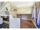Practical laundry area with wood look floors and a modern washer and dryer set for efficient laundry tasks at 1420 N Grandview Ave, Daytona Beach, FL 32118