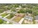 An aerial view of a neighborhood featuring lush trees and well-maintained homes with driveways and established lawns at 1431 1St Ave, Deland, FL 32724