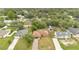 Aerial view of the home, featuring a well-maintained lawn and a long driveway, nestled in a charming neighborhood at 1431 1St Ave, Deland, FL 32724