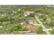 Overhead view of the home and neighborhood, surrounded by mature trees in a peaceful, residential setting at 1431 1St Ave, Deland, FL 32724