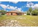 Expansive backyard showing the screened-in lanai, and great yard space with a fire pit feature at 1431 1St Ave, Deland, FL 32724
