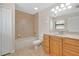 Cozy bathroom with a shower and bathtub, single sink vanity with neutral countertop and tiled floors at 1431 1St Ave, Deland, FL 32724