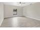 Bright bedroom features wood-look tile flooring, base trim, ceiling fan and natural lighting at 1431 1St Ave, Deland, FL 32724