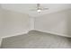 Neutral bedroom showcasing a ceiling fan, base trim and gray wood-look tile flooring at 1431 1St Ave, Deland, FL 32724