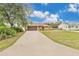 Charming single-story home with well-maintained lawn, long driveway, and a two-car garage at 1431 1St Ave, Deland, FL 32724