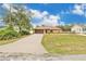 Charming single-story home with well-maintained lawn, long driveway, and a two-car garage at 1431 1St Ave, Deland, FL 32724