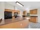 Spacious kitchen featuring black appliances, lots of cabinet space, breakfast bar, and elegant gray tile flooring at 1431 1St Ave, Deland, FL 32724