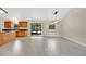 Open-concept kitchen and dining area with tile floors, sliding glass doors, and modern lighting at 1431 1St Ave, Deland, FL 32724