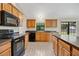 Well-equipped kitchen featuring black appliances, wooden cabinets, and tile flooring at 1431 1St Ave, Deland, FL 32724