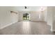 Bright living room featuring tile floors, neutral walls, decorative light fixture, and large windows at 1431 1St Ave, Deland, FL 32724