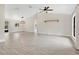 Bright living room featuring tile floors, neutral walls, decorative light fixture, and large windows at 1431 1St Ave, Deland, FL 32724