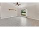 Bright living room featuring tile floors, neutral walls, decorative light fixture, and large windows at 1431 1St Ave, Deland, FL 32724