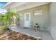 Charming back porch with quaint seating, a white door, and lush greenery accents at 1455 Whitewood Dr, Deltona, FL 32725