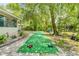 Lush backyard featuring a bocce ball court and mature trees at 1455 Whitewood Dr, Deltona, FL 32725