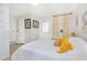 Bright bedroom featuring white walls, wood floors, and a cozy bed with yellow decorative pillows at 1455 Whitewood Dr, Deltona, FL 32725