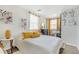 Bright bedroom featuring white walls, wood floors, and a cozy bed with yellow decorative pillows at 1455 Whitewood Dr, Deltona, FL 32725