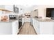 Well-lit kitchen featuring stainless steel appliances, granite countertops, and ample storage space at 1455 Whitewood Dr, Deltona, FL 32725