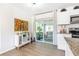 Bright kitchen area with access to an outdoor area and modern countertops and cabinets at 1455 Whitewood Dr, Deltona, FL 32725