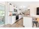 Modern kitchen with white cabinets, stainless steel appliances, and granite countertops at 1455 Whitewood Dr, Deltona, FL 32725