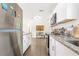 Modern kitchen featuring stainless steel appliances, granite countertops, and white cabinetry at 1455 Whitewood Dr, Deltona, FL 32725