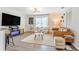 Bright living room with modern decor, wood-look floors, and a large flat-screen television at 1455 Whitewood Dr, Deltona, FL 32725