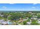 Aerial view showcasing the neighborhood with its proximity to a shimmering lake under a bright sky at 1612 W Grant St, Orlando, FL 32805