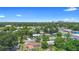 Expansive aerial view of a neighborhood with lush greenery and the city skyline in the background at 1612 W Grant St, Orlando, FL 32805