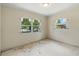 Bedroom with neutral walls and two new windows allowing natural light at 1612 W Grant St, Orlando, FL 32805