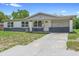 Inviting single-story home with a well-kept lawn and spacious driveway at 1612 W Grant St, Orlando, FL 32805