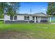 Charming single-story home with a driveway, complemented by green landscaping at 1612 W Grant St, Orlando, FL 32805
