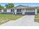 A well-manicured lawn enhances the curb appeal of this inviting single-story house at 1612 W Grant St, Orlando, FL 32805