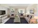 A spacious living room features a stylish couch, cozy chairs and a sleek glass table at 1612 W Grant St, Orlando, FL 32805