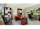 Well-lit home office with a large wooden desk, comfortable chairs, and ample storage space at 1612 W Grant St, Orlando, FL 32805