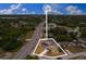 Aerial view of a property with a pool, solar panels, and a large lot near a bustling road at 1660 E Apache Cir, Deltona, FL 32725
